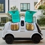 A self-driving delivery firm Nuro's R2 vehicle with groceries inside. (via REUTERS)
