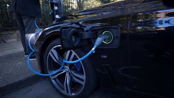 File photo: A driver plugs a cable into a Source power point to charge his electric car in London, Britain. (REUTERS)