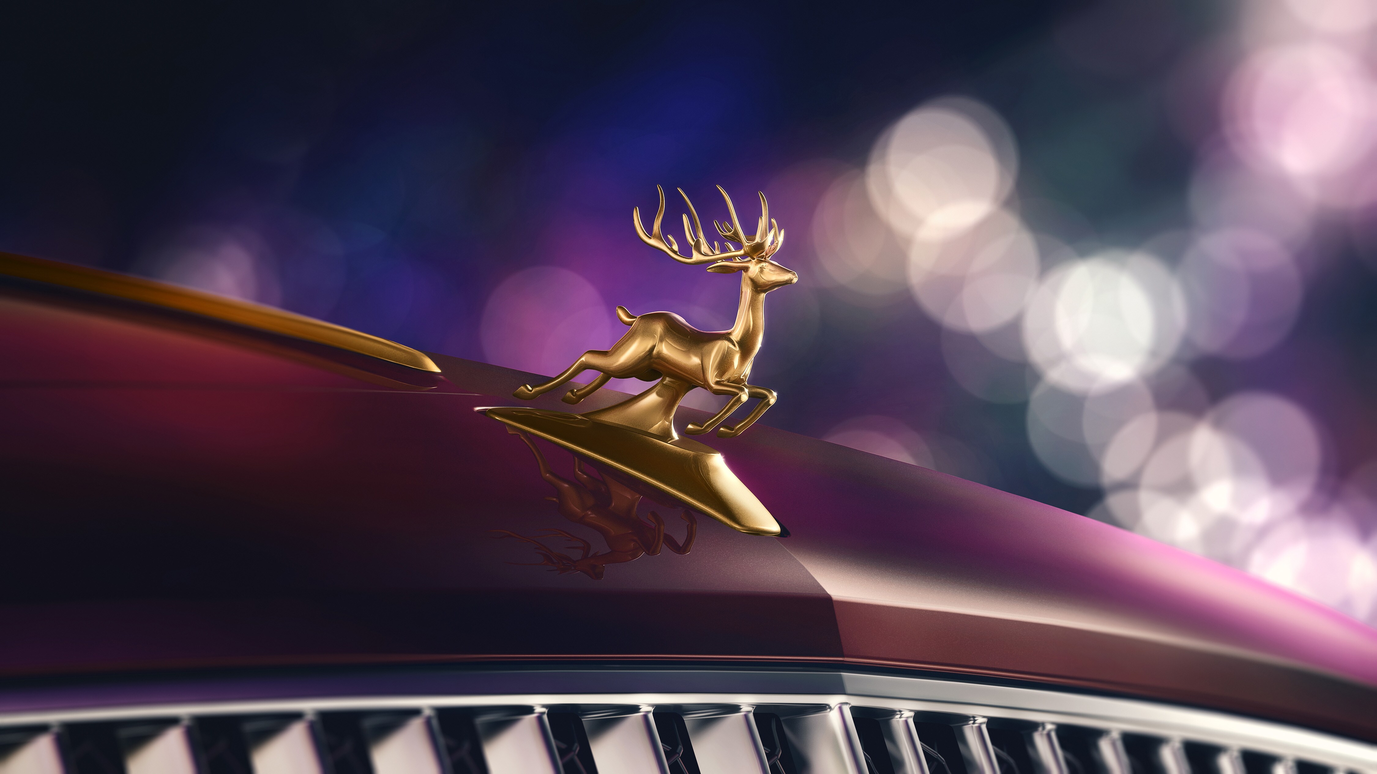 A golden reindeer hood ornament on the car bonnet