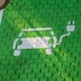 Electric car stencil symbols sit on parking spaces at the electric vehicle charging site in Germany. (Bloomberg)