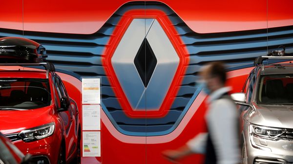 An employee walks past a logo of Renault at a dealership in France. (File photo) (REUTERS)