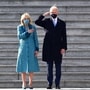 US President Joe Biden (C) salutes as wife US First Lady Jill Biden (L) holds her hand on her heart on the east steps of the US Capitol. (AFP)