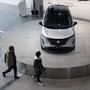 Visitors look at a Nissan Ariya electric crossover sport utility vehicle (SUV) on display inside a showroom. (File photo) (Bloomberg)