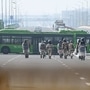 Security personnel stand guard along a blocked highway as farmers continue to take part in a protest against the central government's recent agricultural reforms at the Delhi-Uttar Pradesh state border in Ghazipur. (AFP)