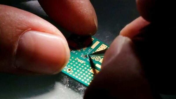 FILE PHOTO: A researcher plants a semiconductor on an interface board during a research work