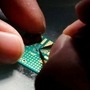 FILE PHOTO: A researcher plants a semiconductor on an interface board during a research work (REUTERS)