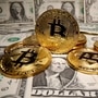 File photo - Representations of virtual currency Bitcoin are placed on US Dollar banknotes. (REUTERS)