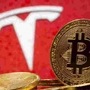 Representations of virtual currency Bitcoin are seen in front of Tesla logo in this illustration taken, February 9, 2021. REUTERS/Dado Ruvic/Illustration/File Photo (REUTERS)