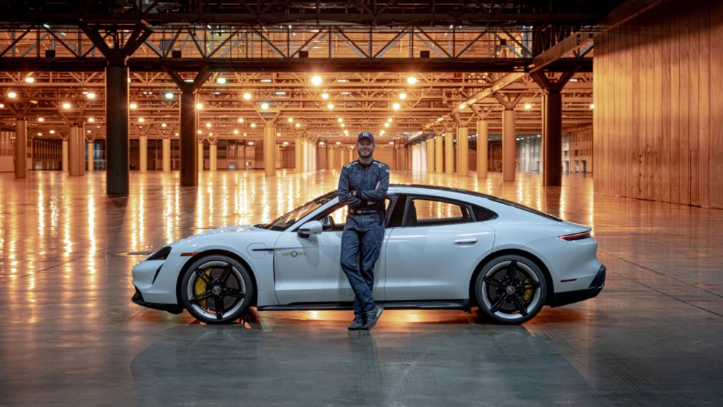 Racing driver Leh Keen with the record-breaking all-electric Porsche Taycan Turbo S. Racing driver Leh Keen with the record-breaking all-electric Porsche Taycan Turbo S.