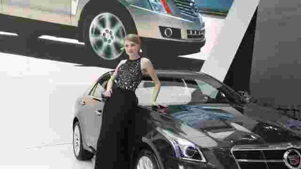 A-model-poses-by-a-Cadillac-CTS-car-at-the-China-International-Exhibition-Center-new-venue-during-the-Auto-China-2014-Beijing-International-Automotive-Exhibition-in-Beijing-on-April-21-2014-Photo-AFP