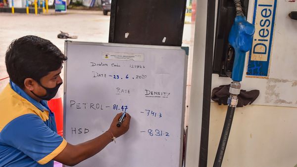 A petrol pump employee writes the increased fuel prices on a board at a petrol pump in Kolkata. (File photo) (PTI)