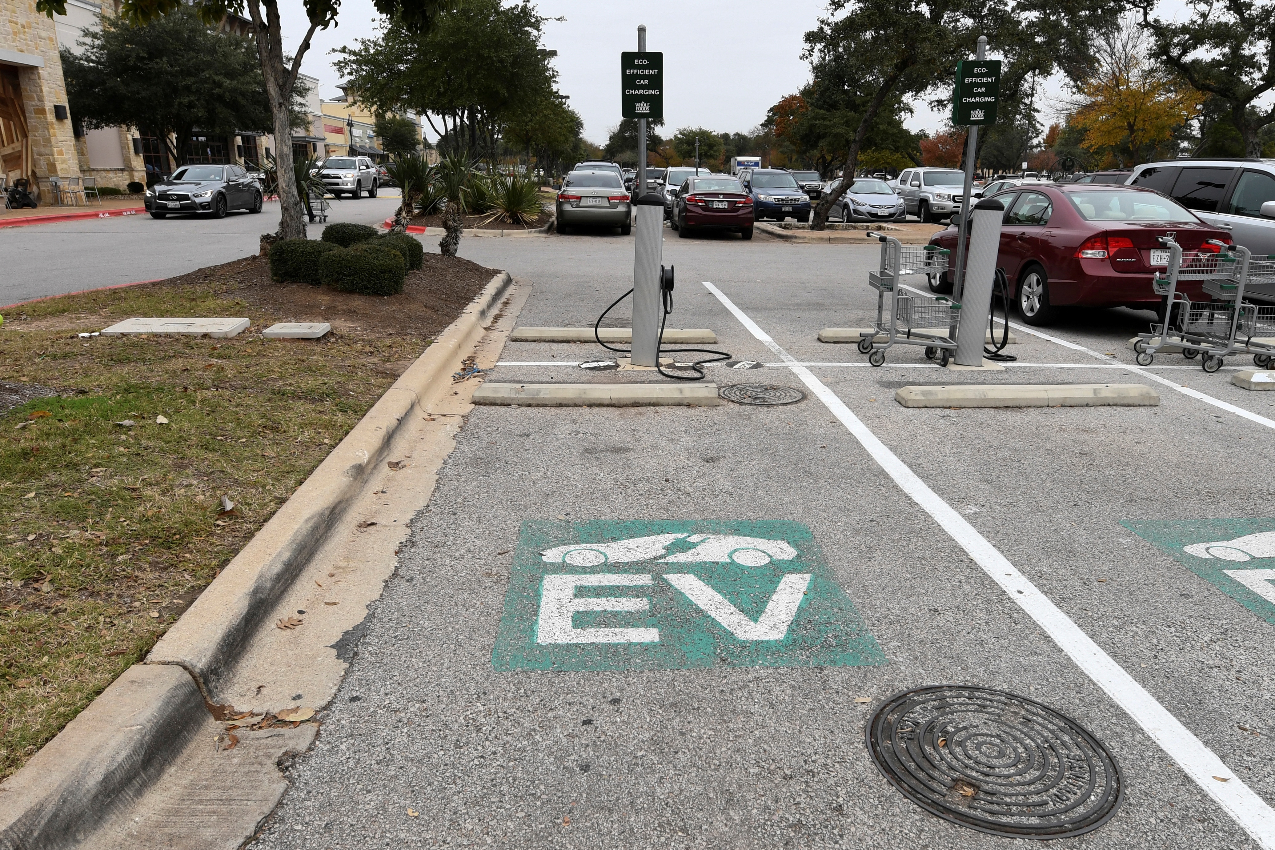 An electric vehicle (EV) fast charging station is seen in the parking lot of a Whole Foods Market in Austin, Texas.