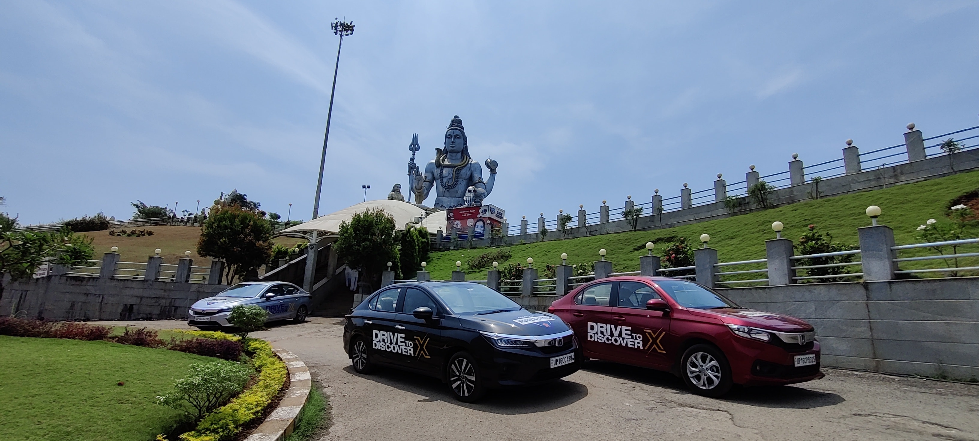 Honda cars parked in front of the world's second tallest Shiva statue. Honda cars parked in front of the world's second tallest Shiva statue.