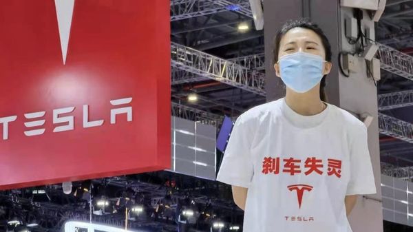 The Tesla owner, wearing a t-shirt that reads Brake Lost Control, was dragged away from the venue and detained for five days for her protest during the Shanghai Auto Show.