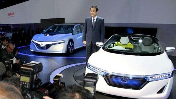 File photo of Honda Motor president Takanobu Ito posing with a car at the Tokyo Motor Show.
