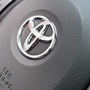 Logos of Toyota (L) and Suzuki (R)