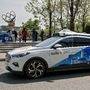A Baidu Apollo Robotaxi passes its customer service counter setup at the Shougang Park in Beijing, Sunday, May 2, 2021.  (AP)