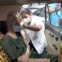 A medic inoculates the dose of the Covid-19 vaccine to a beneficiary during a drive-in-car vaccination drive, at Dadar in Mumbai.