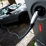 FILE PHOTO: An electric car is seen plugged in at a charging point for electric vehicles. (REUTERS)