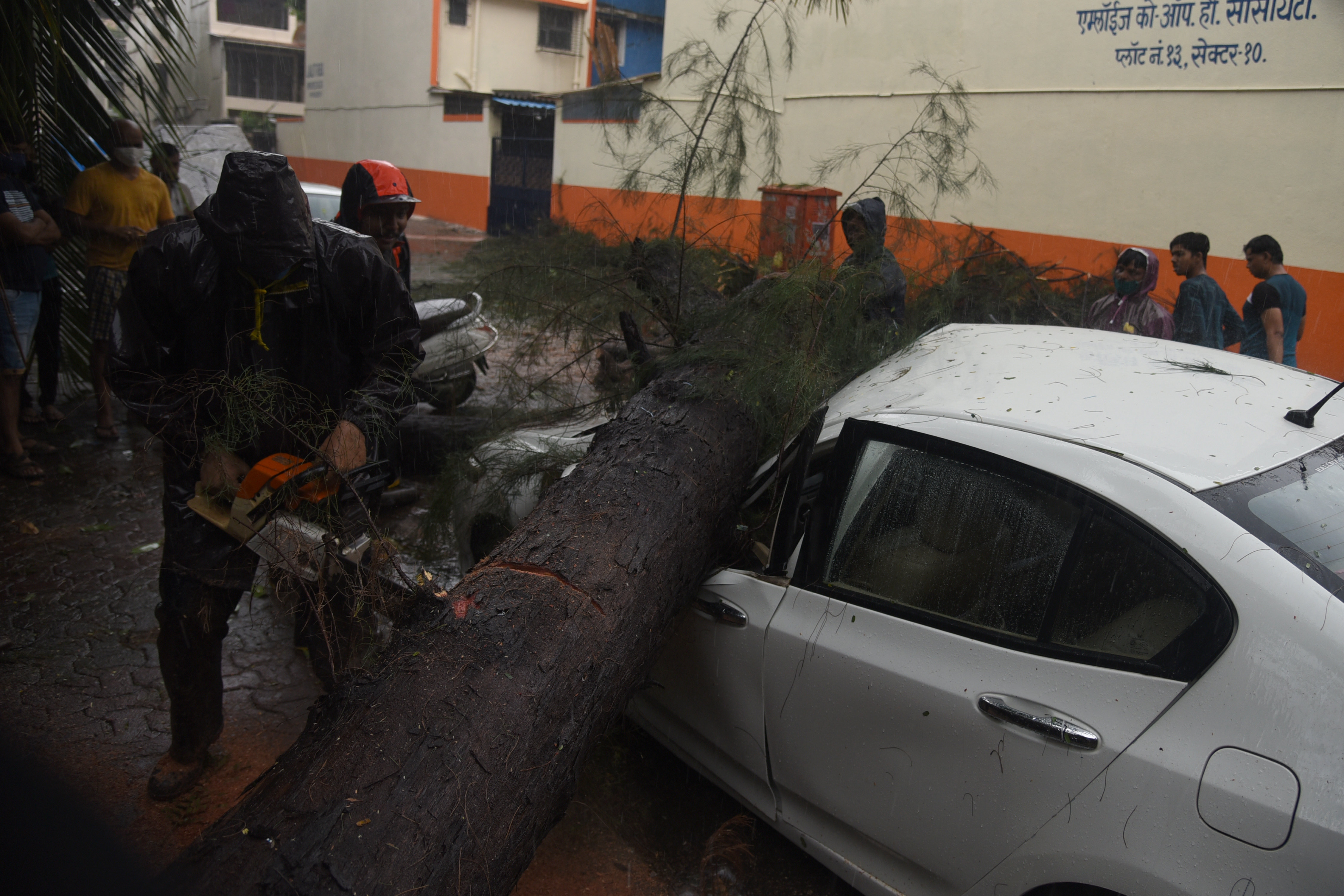 As the speed of the gales went up to 85 kmph many trees were uprooted in the city. Here, a tree fall on a parked Honda Car in Navi Mumbai on Monday. 