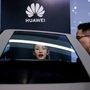 File photo: People check a display near a Huawei logo during a media day for the Auto Shanghai Show in Shanghai. (REUTERS)