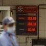 An attendant of a fuel station works as petrol prices cross the 100 rupees per litre mark in Mumbai. (PTI)