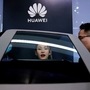 File photo: People check a display near a Huawei logo during a media day for the Auto Shanghai Show in Shanghai. (REUTERS)