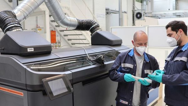 Employees in the middle of quality check of components produced using the binder jetting process in Wolfsburg. (Volkswagen)