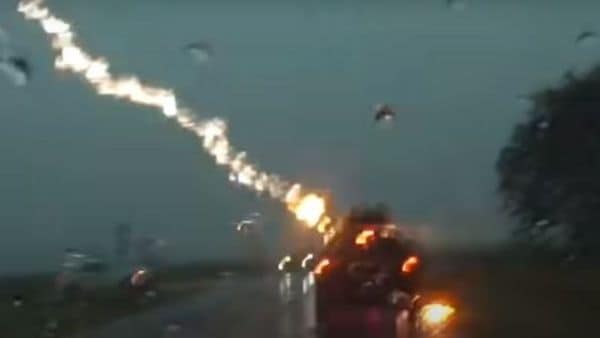 The Grand Cherokee was slowly advancing on a rain-drenched road when the lighting struck the car. (Image: YouTube/LSM)