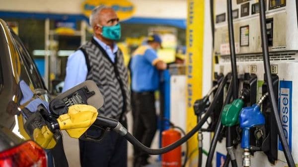 File photo: A man looks at the counter as a vehicles is filled with fuel at a petrol pump in New Delhi. Petrol and diesel prices have seen a significant increase since early parts of May. ( (Amal KS/HT PHOTO))