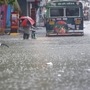 People wade through a waterlogged road after heavy rainfall in Mumbai. (REUTERS)