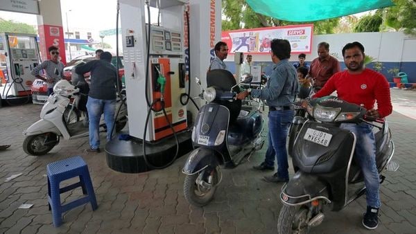 People get their two-wheelers filled with petrol at a fuel station in Ahmedabad.(File photo) (REUTERS)