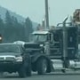 The pickup truck was seen towing a semi-truck loaded with logs on July 10 in Canada. (Image: Youtube/Viralhog)