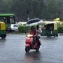 Commuters seen near Delhi Gate on a rain-drenched Tuesday evening. (Arvind Yadav/HT PHOTO)