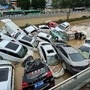 Cars sit in floodwaters after heavy rains hit the city of Zhengzhou in China's central Henan province on July 21, 2021. (AFP)
