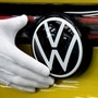 File photo: An employee cleans the paint in the final inspection at the production line for the electric Volkswagen model ID.4 electric car. (REUTERS)