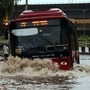 File photo: A DTC bus makes its way through a flooded street in Delhi.