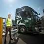 Stuart Watts, a director of Glenfiddich parent company William Grant & Sons, stands by a fuelling station next to their truck, that runs on whiskey-by-product based biogas, in Dufftown, Scotland, Britain in this undated handout obtained July 26, 2021. (Courtesy of William Grant & Sons) (via REUTERS)