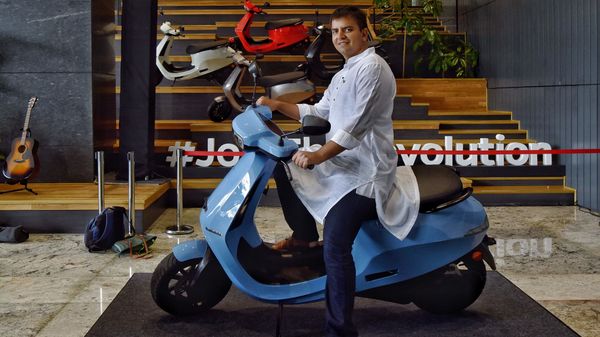 Bhavish Aggarwal, Co-founder and CEO of Ola, poses for a photograph with the new Ola electric scooter during its launch at the Ola headquarters in Bangalore on August 15, 2021. (AFP)