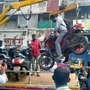 Motorcycle being towed along with the rider in Pune.