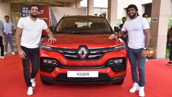 Indian wrestlers Ravi Kumar Dahiya and Bajrang Punia pose with Renault Kiger SUV. While Dahiya won Silver, Punia won Bronze medal for India at the Tokyo Olympics 2021.