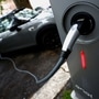 An electric car is seen plugged in at a charging point for electric vehicles. (File photo used for representational purpose only) (REUTERS)