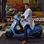 Bhavish Aggarwal, Co-founder and CEO of Ola, poses for a photograph with the new Ola electric scooter during its launch at the Ola headquarters in Bangalore on August 15, 2021. (AFP)