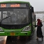 File photo: A woman getting on to a DTC bus while it rains on a National Highway near Pandav Nagar in New Delhi, India, (Ajay Aggarwal /HT PHOTO)