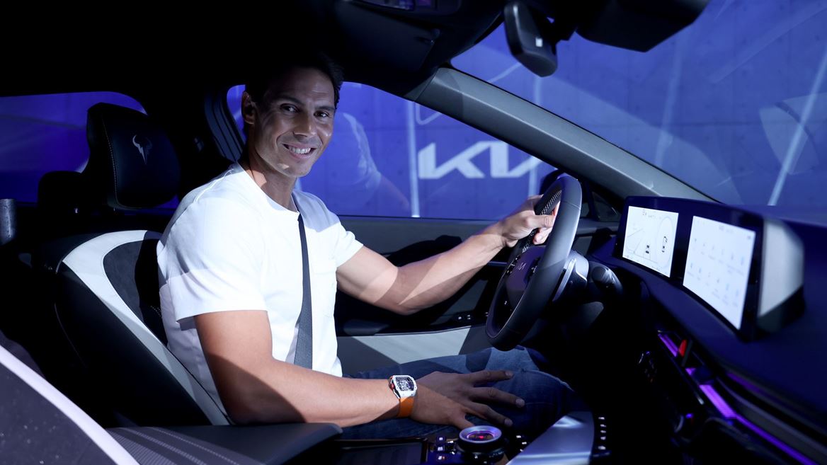 Rafael Nadal sits inside his new Kia EV6 vehicle.