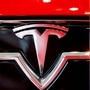 File photo of Tesla logo (L) and CEO Elon Musk (R)