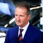 File photo of Volkswagen CEO Herbert Diess (L) and Tesla logo (R).