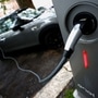 An electric car is seen plugged in at a charging point for electric vehicles. (File photo used for representational purpose only). (REUTERS)