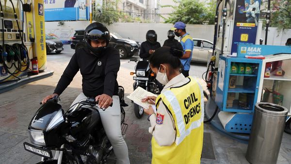 Civil Defence personnel checks the Pollution Certificate of a vehicle before refueling petrol amid rising air pollution in the city at the petrol station, in New Delhi. (ANI)