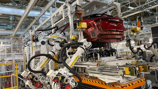 File photo: Robotic arms put in the electric vehicle powertrain into the Ariya model in the assembly line at Nissan's Tochigi plant in Kaminokawa town,  (AP)